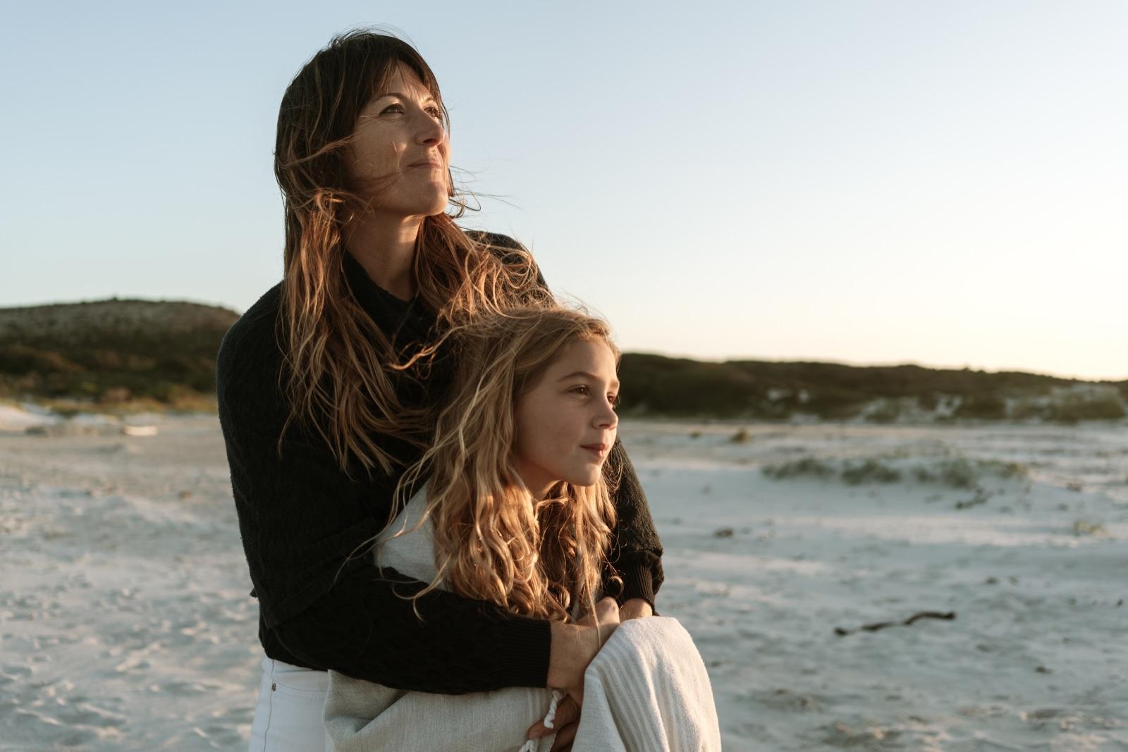 Mother and daughter at the beach, golden hour
